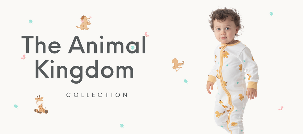 Toddler boy wearing Little Moy's animal kingdom organic cotton romper